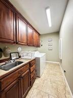 28 Angelfish Ct, Russellville, AR 72802 - laundry room with baseboards, separate washer and dryer, a sink, and cabinet space