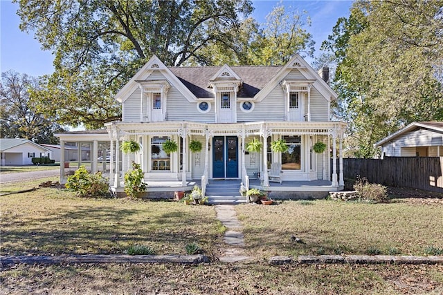 601 N Front St, Dardanelle, AR 72834 - victorian-style house featuring a front lawn, covered porch, and fence