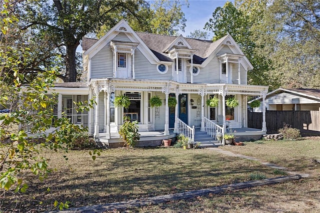 601 N Front St, Dardanelle, AR 72834 - victorian house featuring covered porch, fence, and a front yard