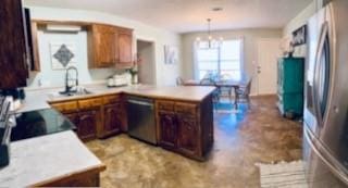 130 Willow Creek Dr, Dardanelle, AR 72834 - kitchen with stainless steel appliances, a chandelier, a peninsula, and light countertops