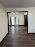 hallway featuring wood finished floors and baseboards