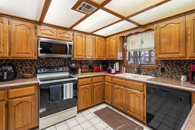 kitchen with stainless steel microwave, a sink, range with electric cooktop, black dishwasher, and visible vents
