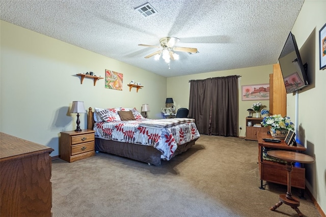 bedroom with carpet flooring, a textured ceiling, visible vents, and ceiling fan