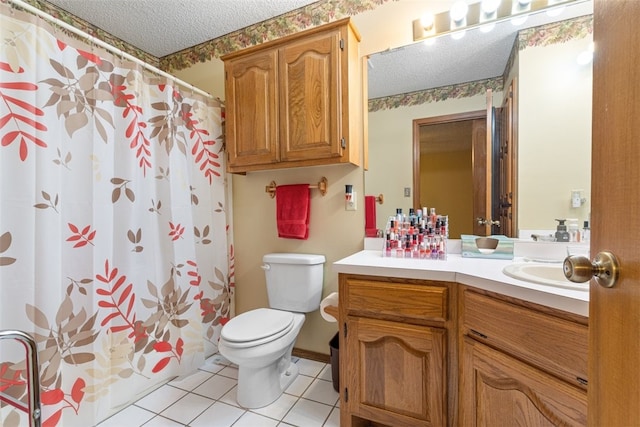 bathroom featuring a shower with curtain, tile patterned flooring, vanity, toilet, and a textured ceiling