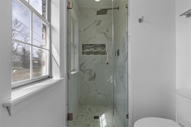 full bath featuring a marble finish shower and toilet