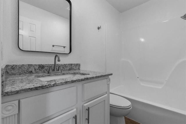 full bathroom with shower / washtub combination, toilet, vanity, and wood finished floors