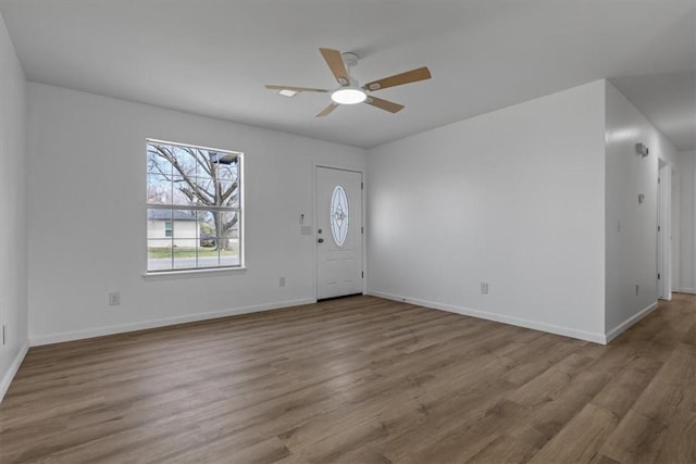 entryway featuring baseboards, wood finished floors, and ceiling fan
