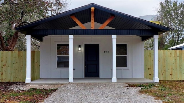 402 NE 4th Ave, Gravette, AR 72736 - view of front of home featuring covered porch and board and batten siding