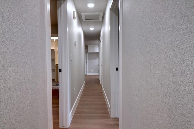 402 NE 4th Ave, Gravette, AR 72736 - corridor with wood finished floors, a textured wall, baseboards, and attic access