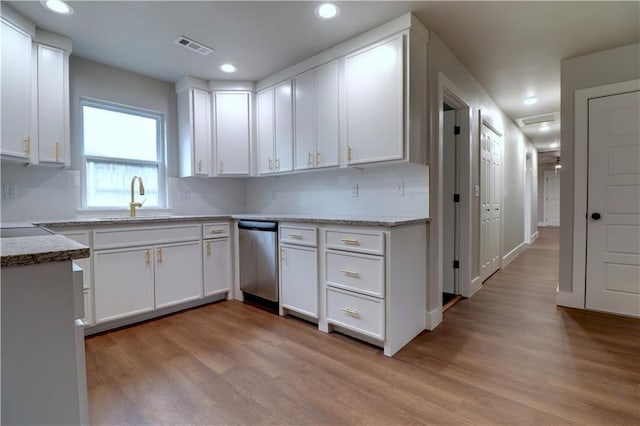 402 NE 4th Ave, Gravette, AR 72736 - kitchen with stainless steel dishwasher, a sink, light wood finished floors, white cabinetry, and recessed lighting