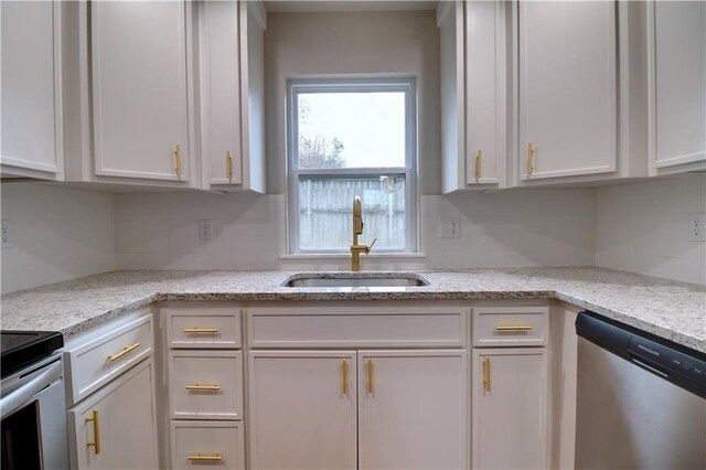 402 NE 4th Ave, Gravette, AR 72736 - kitchen featuring stainless steel appliances, a sink, white cabinets, and decorative backsplash
