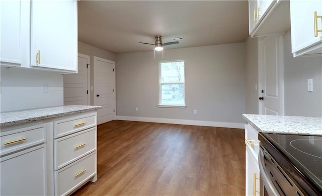 402 NE 4th Ave, Gravette, AR 72736 - kitchen featuring light wood-style floors, baseboards, and white cabinets