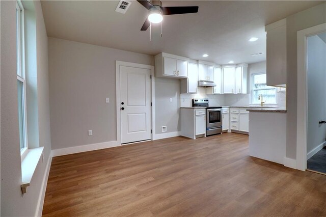 402 NE 4th Ave, Gravette, AR 72736 - kitchen featuring stainless steel range with electric cooktop, under cabinet range hood, ceiling fan, light wood finished floors, and recessed lighting