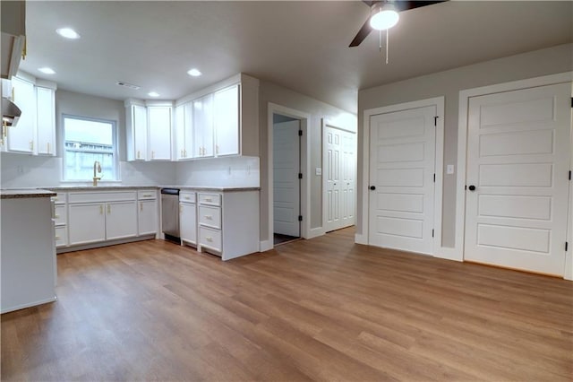 402 NE 4th Ave, Gravette, AR 72736 - kitchen featuring dishwasher, light wood-style floors, ceiling fan, a sink, and white cabinetry