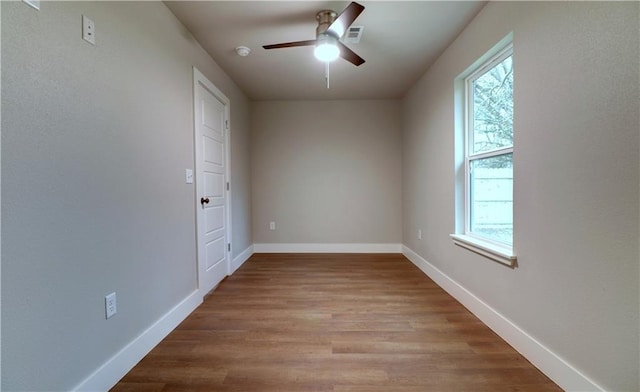 402 NE 4th Ave, Gravette, AR 72736 - unfurnished room with plenty of natural light, a ceiling fan, and wood finished floors