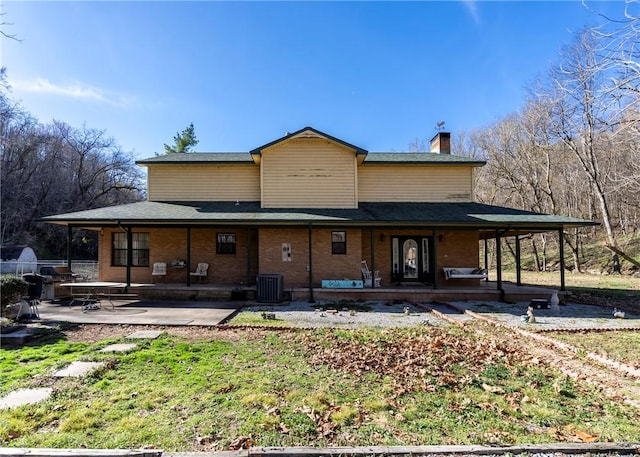 22965 Davis Valley Rd, Gentry, AR 72734 - back of property featuring a chimney, central air condition unit, brick siding, and a patio area