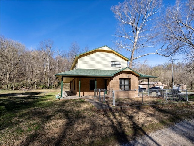 22965 Davis Valley Rd, Gentry, AR 72734 - view of front facade featuring roof with shingles, fence, a front yard, brick siding, and a porch