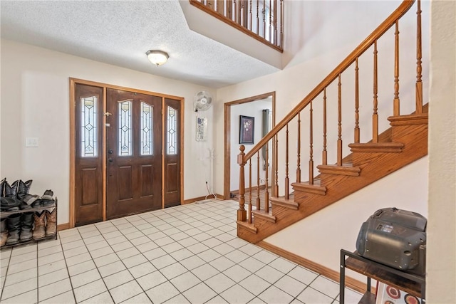 22965 Davis Valley Rd, Gentry, AR 72734 - entryway featuring stairs, light tile patterned floors, baseboards, and a textured ceiling