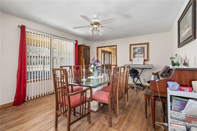 22965 Davis Valley Rd, Gentry, AR 72734 - dining area featuring a ceiling fan, a textured ceiling, baseboards, and wood finished floors