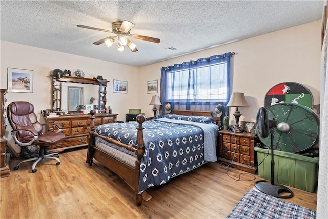 22965 Davis Valley Rd, Gentry, AR 72734 - bedroom with visible vents, a ceiling fan, wood finished floors, and a textured ceiling