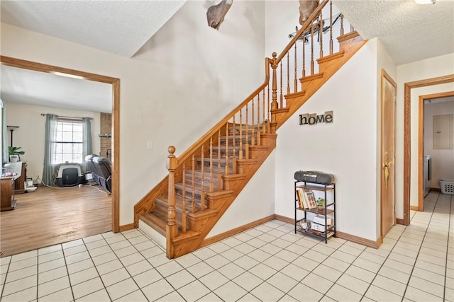 22965 Davis Valley Rd, Gentry, AR 72734 - staircase featuring tile patterned floors, baseboards, and a textured ceiling