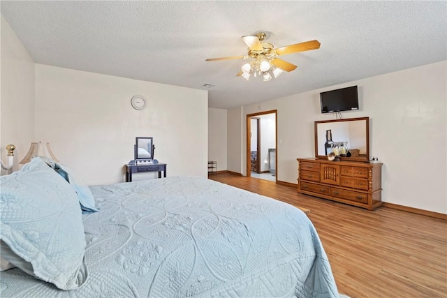 22965 Davis Valley Rd, Gentry, AR 72734 - bedroom with a ceiling fan, a textured ceiling, baseboards, and wood finished floors
