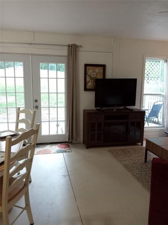 living room with concrete floors and french doors