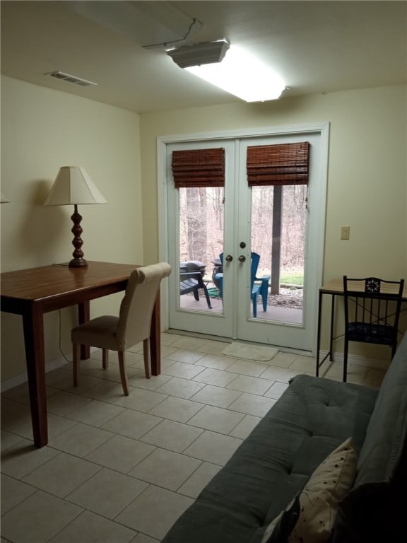 interior space with french doors, light tile patterned floors, and visible vents