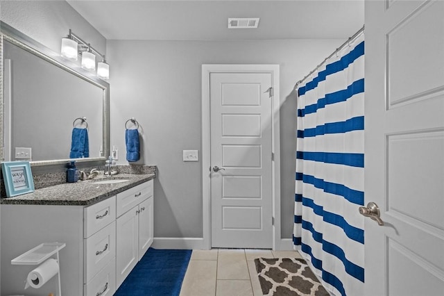 4204 SW Wheatgrass Blvd, Bentonville, AR 72713 - bathroom featuring tile patterned floors, vanity, and baseboards