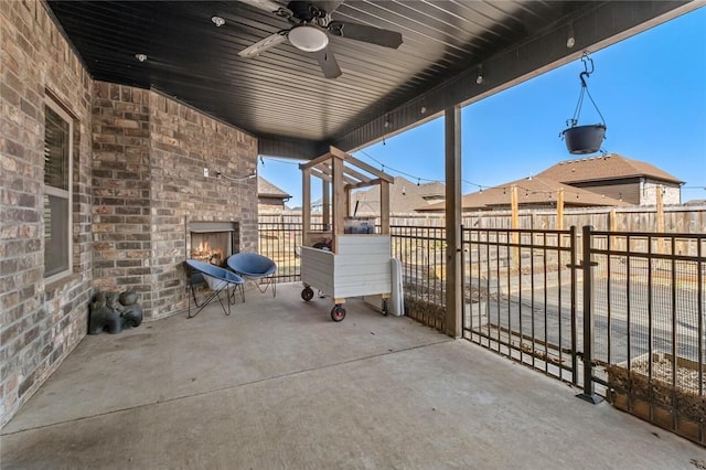 4204 SW Wheatgrass Blvd, Bentonville, AR 72713 - fenced backyard featuring an outdoor brick fireplace, a patio, and a ceiling fan