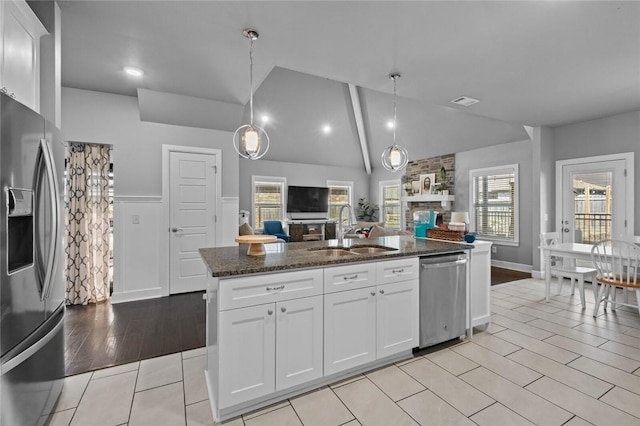 4204 SW Wheatgrass Blvd, Bentonville, AR 72713 - kitchen featuring a sink, stainless steel appliances, open floor plan, dark stone countertops, and white cabinetry