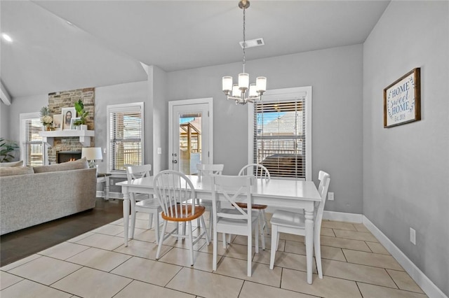 4204 SW Wheatgrass Blvd, Bentonville, AR 72713 - dining space featuring healthy amount of natural light, a chandelier, a fireplace, and baseboards