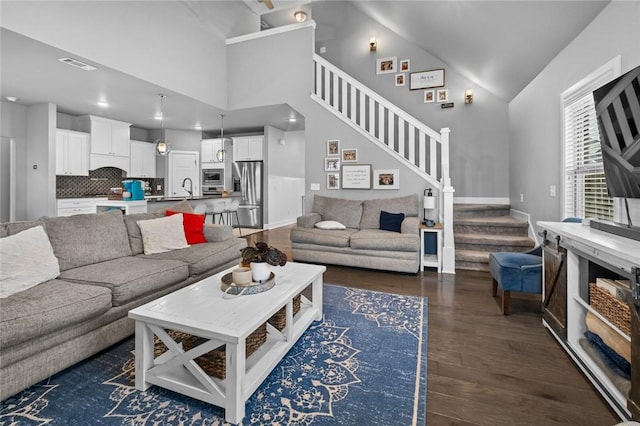 4204 SW Wheatgrass Blvd, Bentonville, AR 72713 - living room featuring stairs, wood finished floors, vaulted ceiling, baseboards, and recessed lighting
