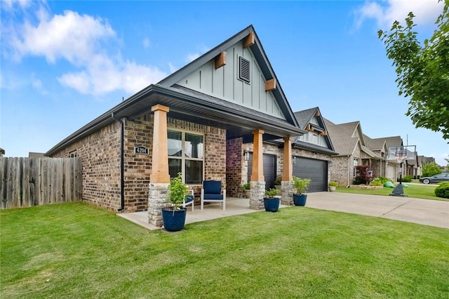 4204 SW Wheatgrass Blvd, Bentonville, AR 72713 - view of front of property with board and batten siding, driveway, covered porch, a garage, and stone siding