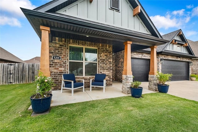 4204 SW Wheatgrass Blvd, Bentonville, AR 72713 - view of front of home featuring board and batten siding, driveway, brick siding, and a garage