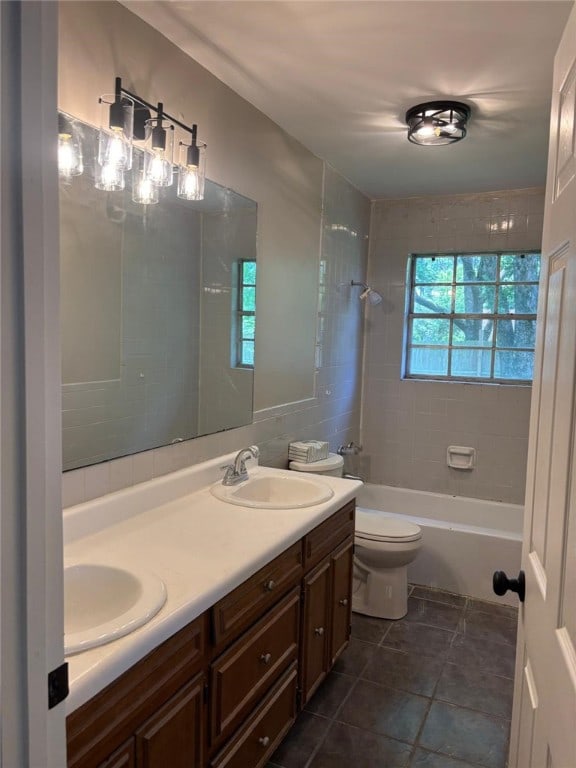 bathroom with tile patterned flooring, double vanity, toilet, and bathtub / shower combination