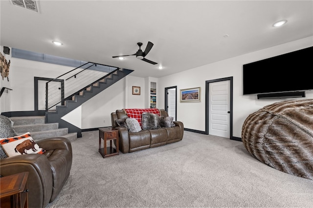 1904 NE Frost Dr, Bentonville, AR 72712 - carpeted living room with baseboards, visible vents, stairway, and a ceiling fan