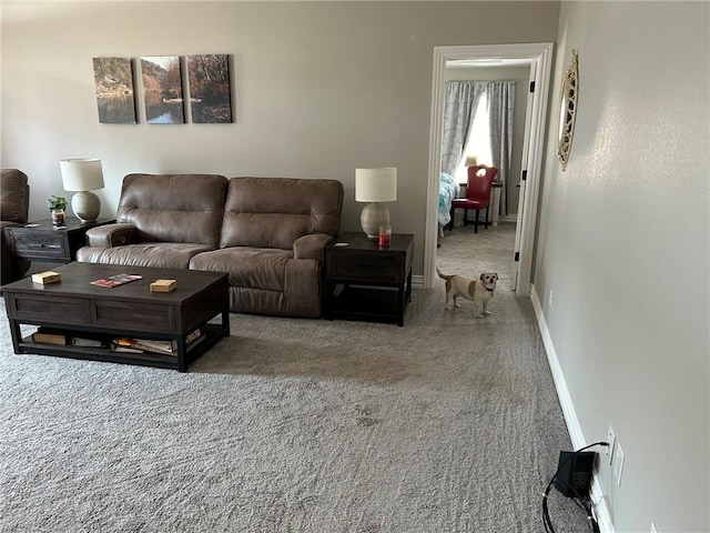 living area featuring carpet flooring and baseboards