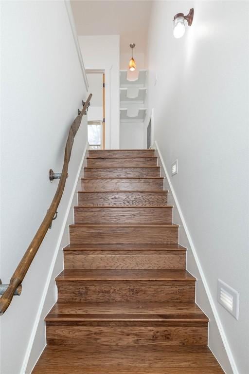 stairway with wood finished floors