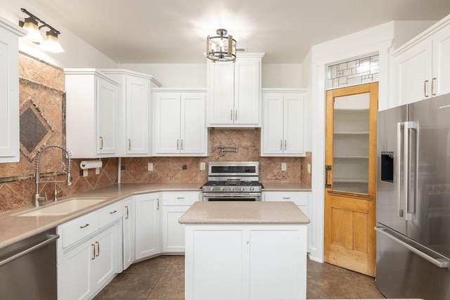 kitchen featuring light countertops, white cabinets, tasteful backsplash, a sink, and stainless steel appliances