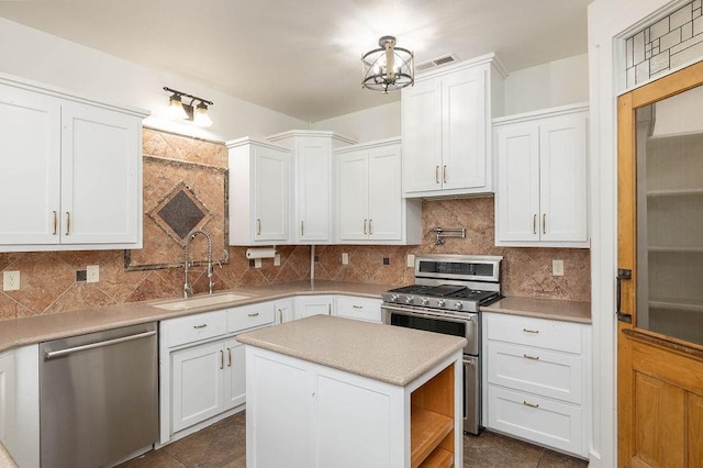 kitchen featuring stainless steel appliances, open shelves, white cabinetry, and a sink