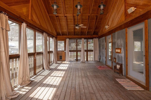 unfurnished sunroom featuring wood-type flooring, vaulted ceiling, a healthy amount of sunlight, and wood ceiling