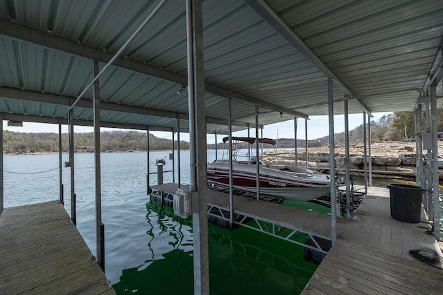 dock area with boat lift and a water view