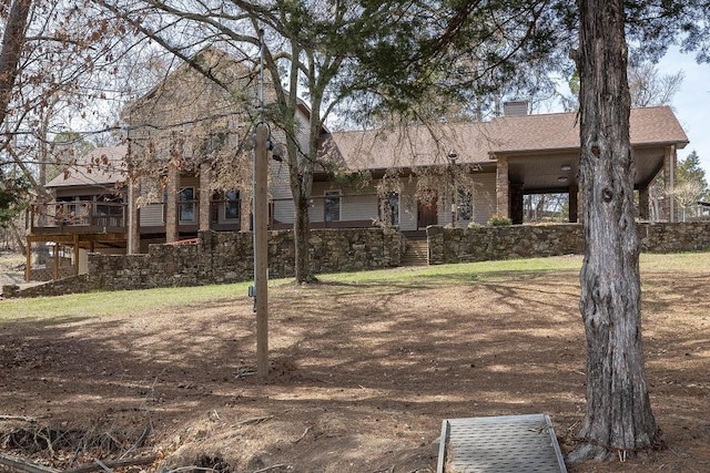 view of front of house with roof with shingles and a chimney