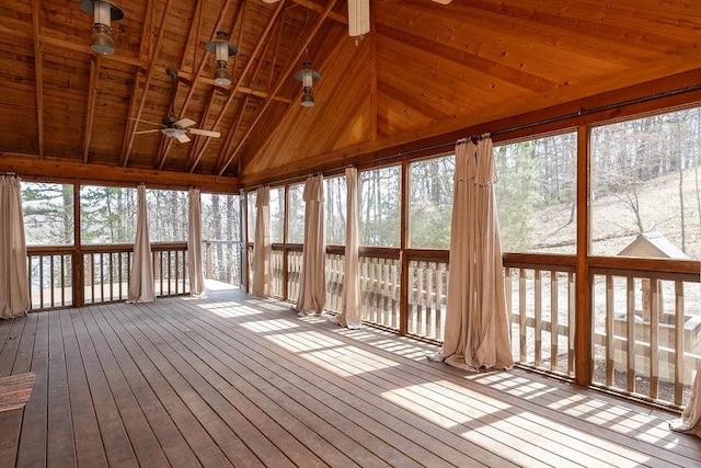 unfurnished sunroom featuring ceiling fan