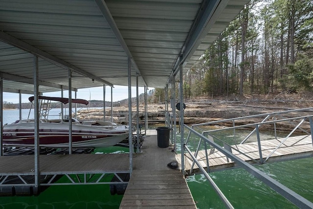 dock area with boat lift and a water view