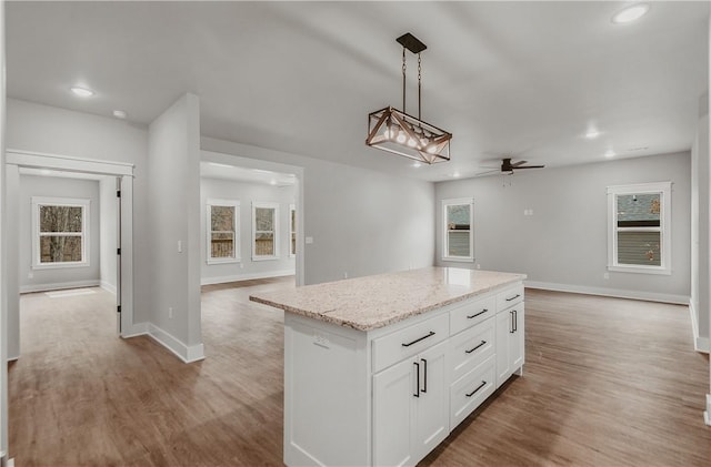 9 Beaty Ln, Bella Vista, AR 72715 - kitchen featuring light wood-style floors, open floor plan, pendant lighting, and a ceiling fan