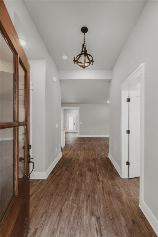 9 Beaty Ln, Bella Vista, AR 72715 - entryway featuring a chandelier, dark wood-type flooring, and baseboards