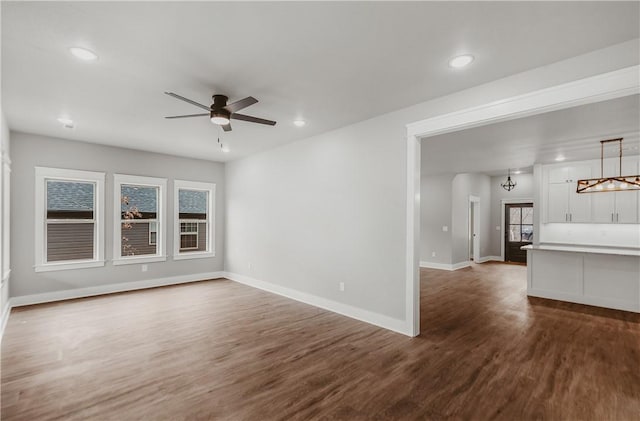 9 Beaty Ln, Bella Vista, AR 72715 - unfurnished living room featuring baseboards, recessed lighting, ceiling fan, and dark wood-style floors