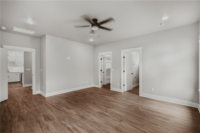 9 Beaty Ln, Bella Vista, AR 72715 - unfurnished bedroom featuring a spacious closet, visible vents, baseboards, and wood finished floors
